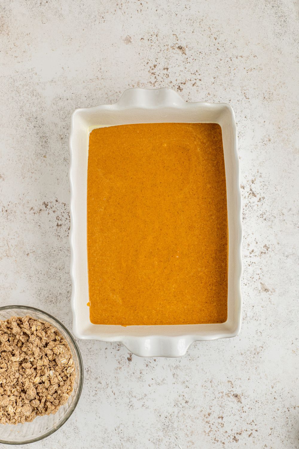 raw pumpkin puree poured into a 9x13 pan 