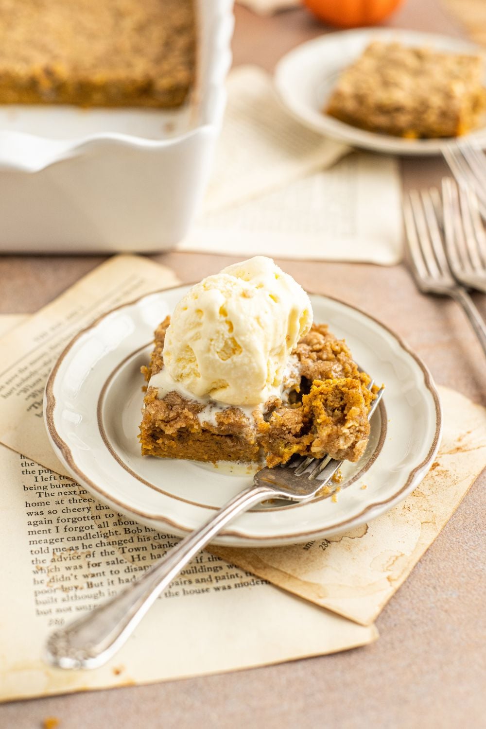 Homemade Pumpkin Crisp sliced and placed on plate and then a few bites taken from the plate 