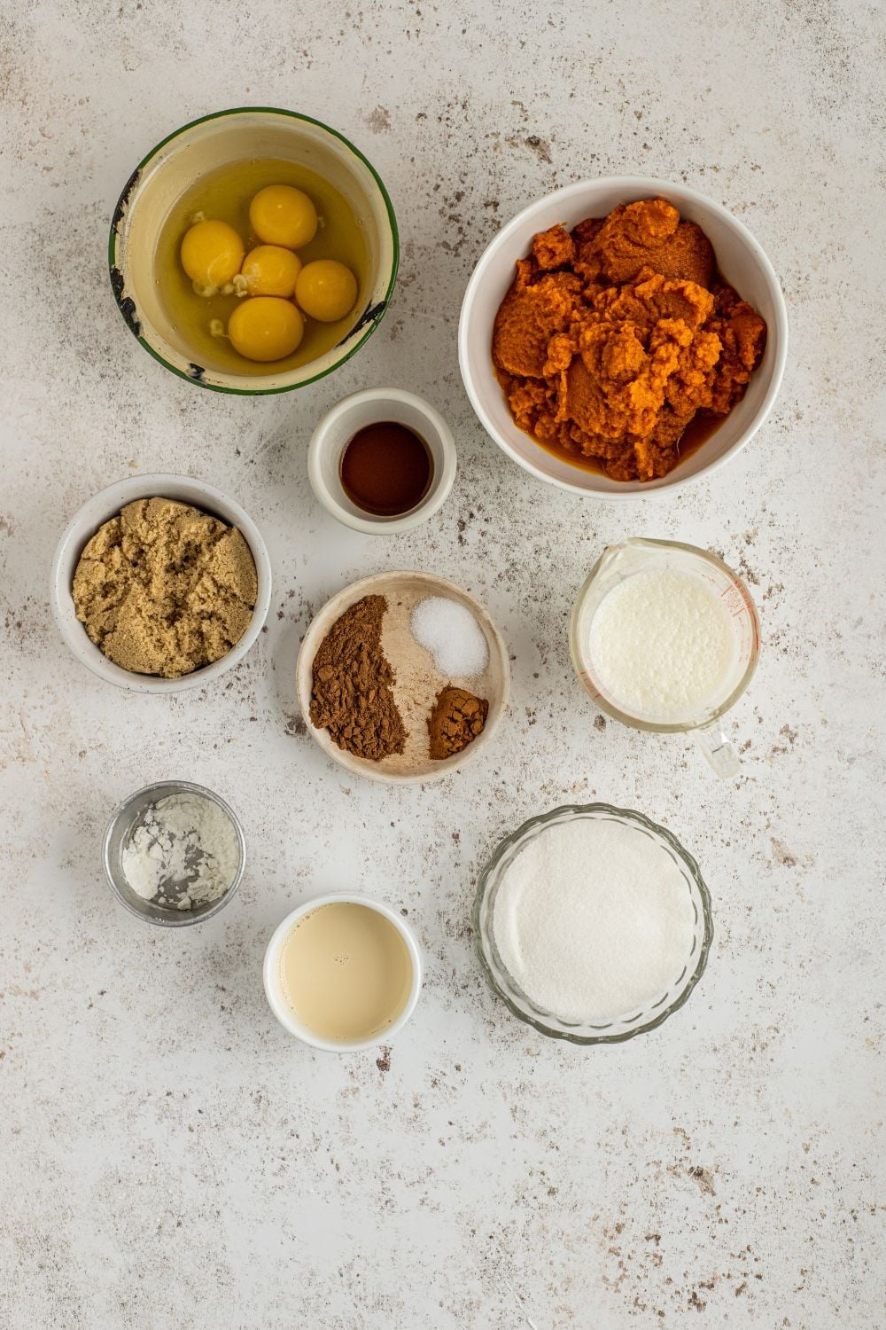 all the ingredients for pumpkin pie crisp in single serve bowls on table 